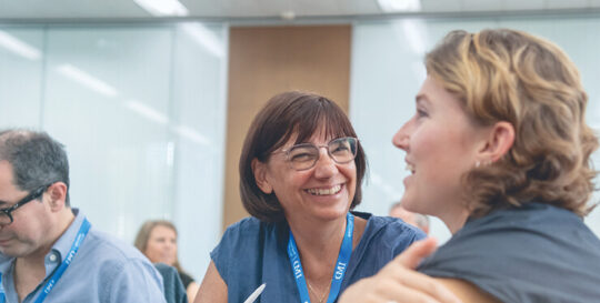 Two women participants having an in-class discussion