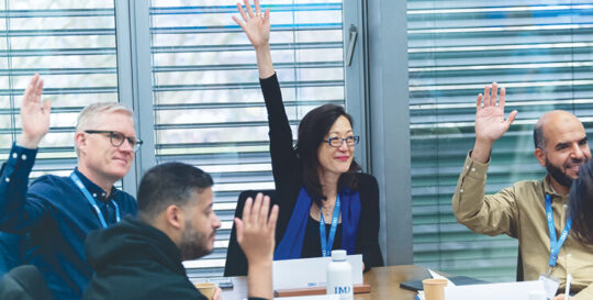 Open program participants raising their hands on class